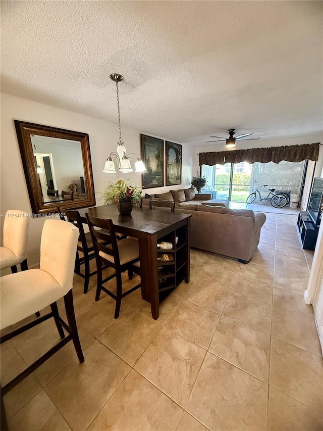 2371 SW 15th St Unit 101, Deerfield Beach, FL 33442 - dining space with a textured ceiling, light tile patterned floors, ceiling fan, and a chandelier