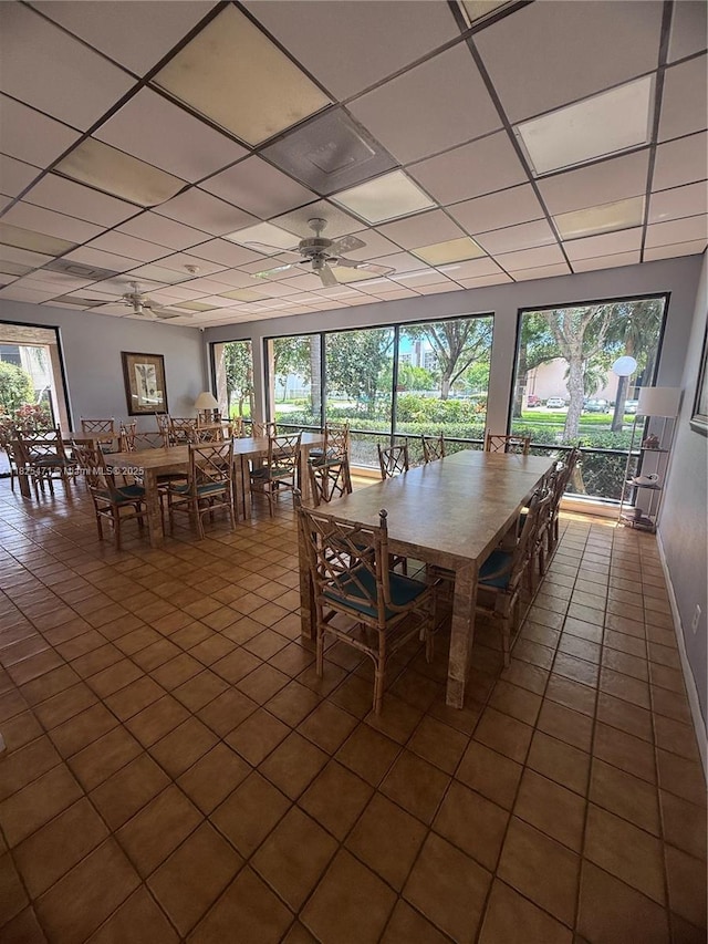 2371 SW 15th St Unit 101, Deerfield Beach, FL 33442 - dining space with a ceiling fan, a paneled ceiling, healthy amount of natural light, and dark tile patterned floors