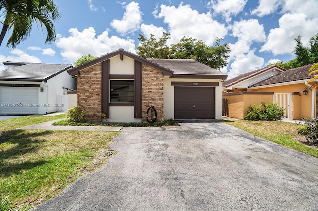 17625 NW 62nd Ct, Hialeah, FL 33015 - mid-century home featuring driveway, a garage, stucco siding, and brick siding