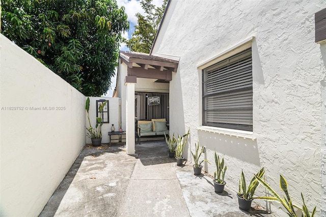 17625 NW 62nd Ct, Hialeah, FL 33015 - view of exterior entry with stucco siding and a patio area