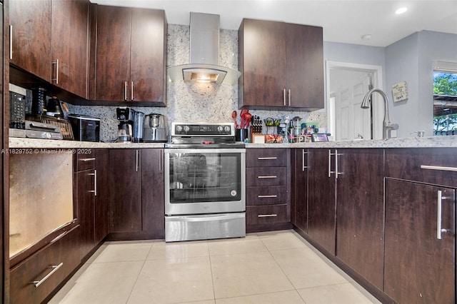 17625 NW 62nd Ct, Hialeah, FL 33015 - kitchen featuring stainless steel range with electric cooktop, wall chimney exhaust hood, backsplash, light tile patterned floors, and dark brown cabinetry