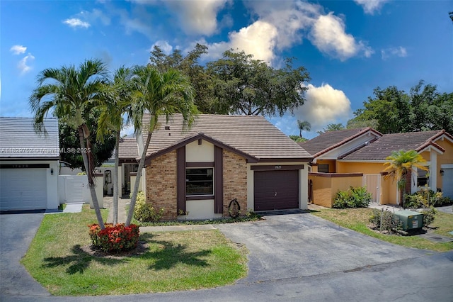 17625 NW 62nd Ct, Hialeah, FL 33015 - single story home with driveway, an attached garage, a tiled roof, stucco siding, and brick siding