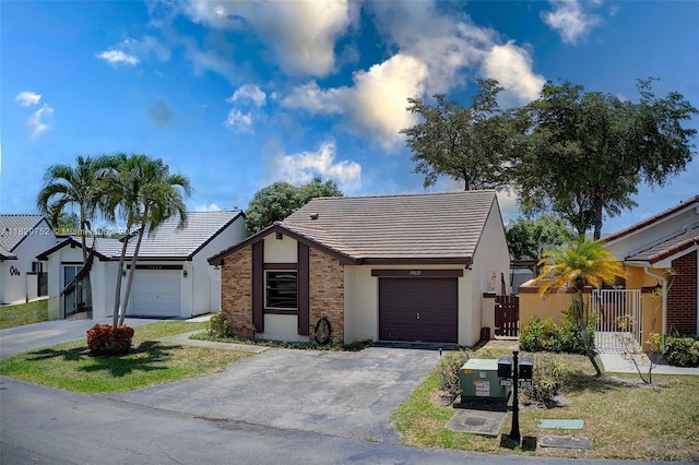 17625 NW 62nd Ct, Hialeah, FL 33015 - view of front of property with a garage, driveway, a gate, and a tile roof