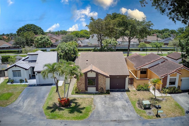 17625 NW 62nd Ct, Hialeah, FL 33015 - view of front facade with driveway, a residential view, a tile roof, and stucco siding