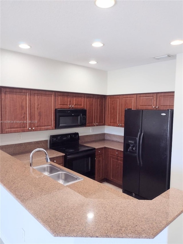 8380 SW 25th Ct Unit 104, Miramar, FL 33025 - kitchen featuring black appliances, a peninsula, and recessed lighting