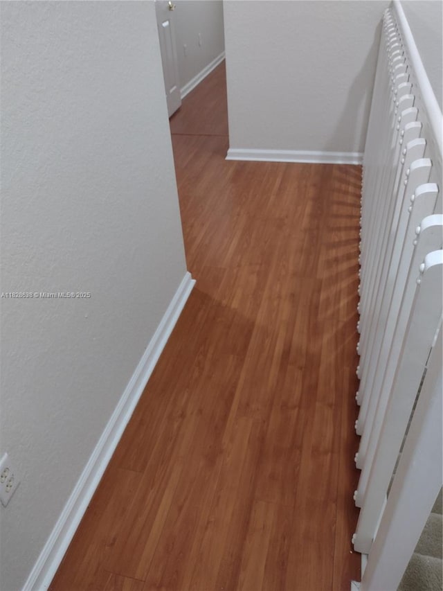 8380 SW 25th Ct Unit 104, Miramar, FL 33025 - hallway with baseboards and wood finished floors
