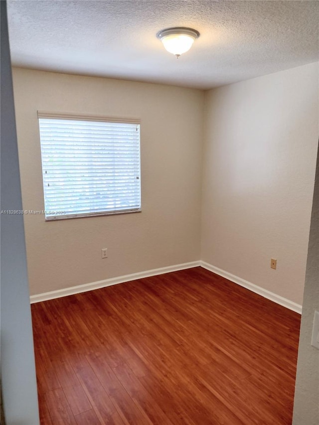 8380 SW 25th Ct Unit 104, Miramar, FL 33025 - spare room with wood finished floors and a textured ceiling