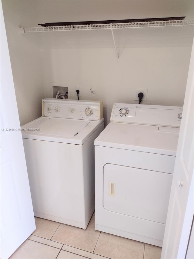 8380 SW 25th Ct Unit 104, Miramar, FL 33025 - laundry area with washing machine and clothes dryer and light tile patterned floors
