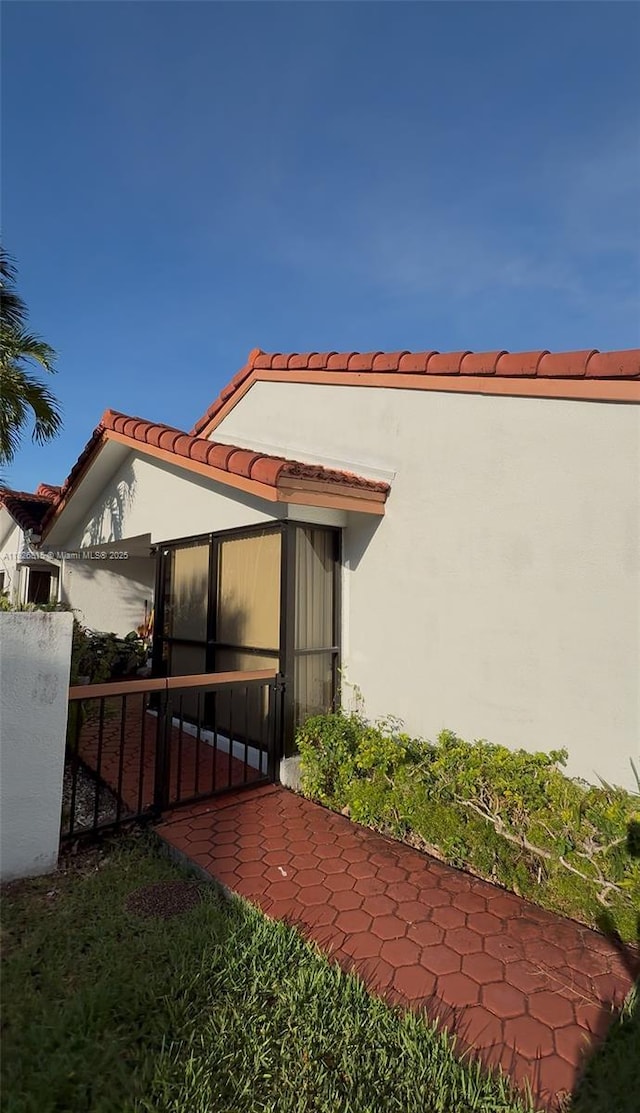 7440 SW 153rd Ct Unit 107-4, Miami, FL 33193 - view of side of home featuring stucco siding and a tile roof