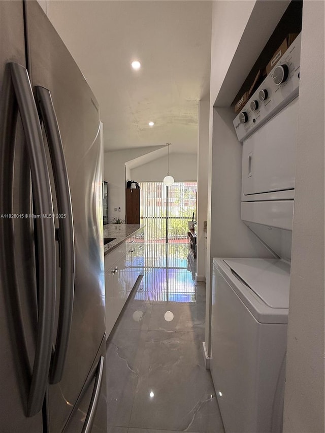 7440 SW 153rd Ct Unit 107-4, Miami, FL 33193 - washroom with stacked washer and clothes dryer, recessed lighting, and marble tiled floors