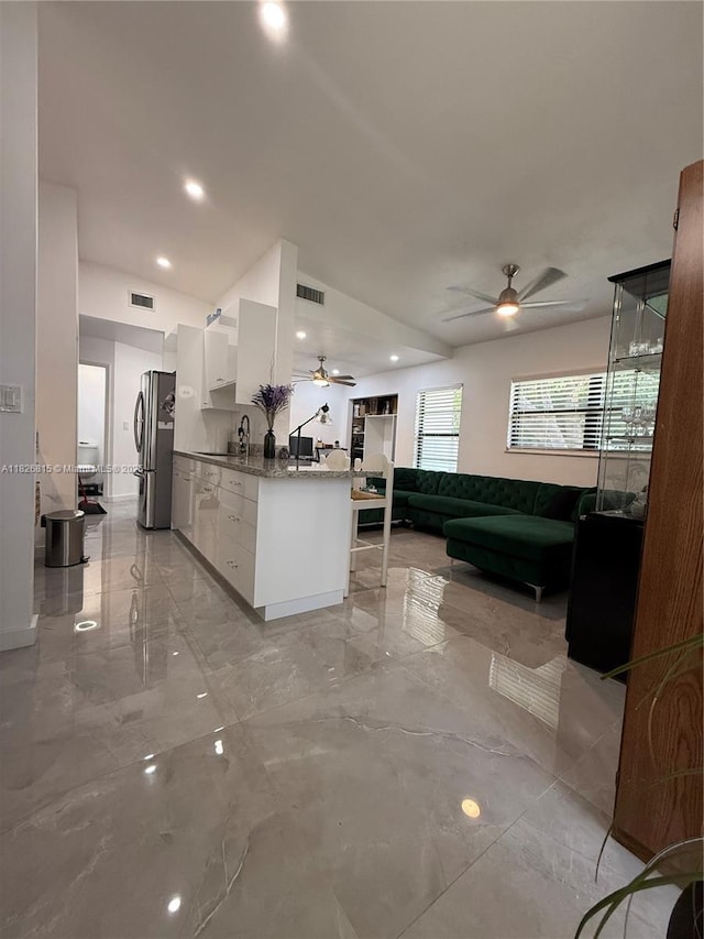 7440 SW 153rd Ct Unit 107-4, Miami, FL 33193 - kitchen with a ceiling fan, freestanding refrigerator, modern cabinets, white cabinets, and light marble finish floors