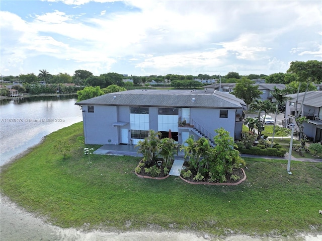 13261 SW 17th Ln, Miami, FL 33175 - view of front of house with a water view, a front yard, a patio area, and stairs