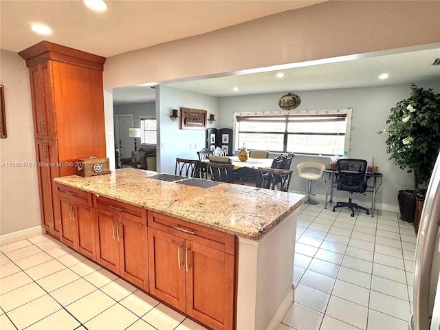 13261 SW 17th Ln, Miami, FL 33175 - kitchen with a peninsula, light tile patterned floors, recessed lighting, brown cabinets, and plenty of natural light