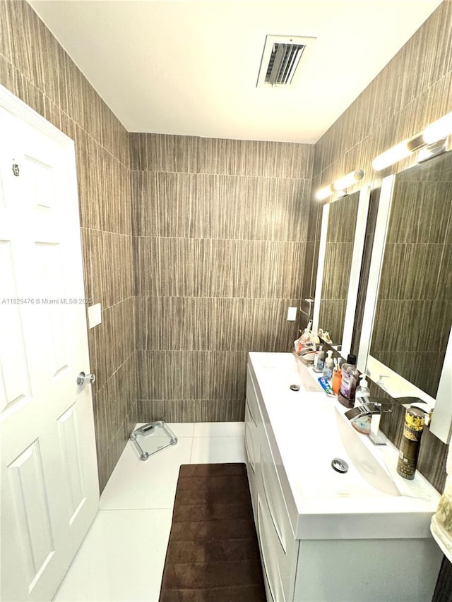 13261 SW 17th Ln, Miami, FL 33175 - bathroom featuring tile walls, vanity, and tile patterned floors