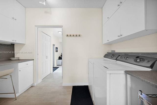 15730 SW 87th Ct, Palmetto Bay, FL 33157 - laundry area with cabinet space, washer and clothes dryer, and light wood-style floors