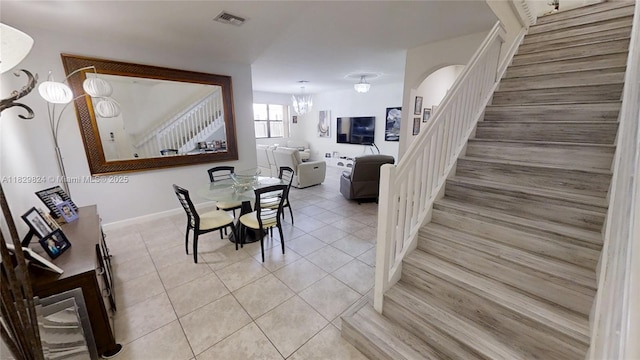 4231 SW 165th Ct, Miami, FL 33185 - dining area featuring a chandelier, tile patterned flooring, and stairway