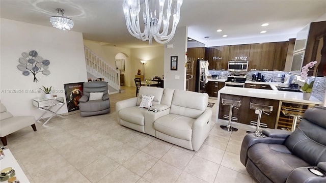 4231 SW 165th Ct, Miami, FL 33185 - living room with a chandelier, stairs, arched walkways, recessed lighting, and light tile patterned floors