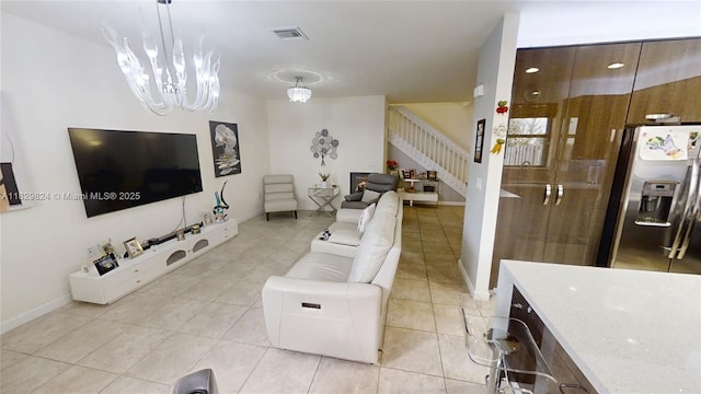4231 SW 165th Ct, Miami, FL 33185 - living room featuring stairway, light tile patterned floors, and a chandelier