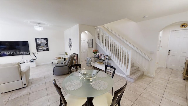 4231 SW 165th Ct, Miami, FL 33185 - dining area with arched walkways, light tile patterned flooring, and stairs