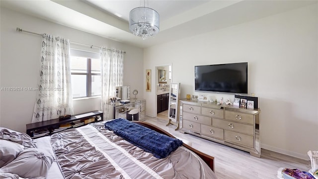 4231 SW 165th Ct, Miami, FL 33185 - bedroom featuring a chandelier, light wood finished floors, and connected bathroom