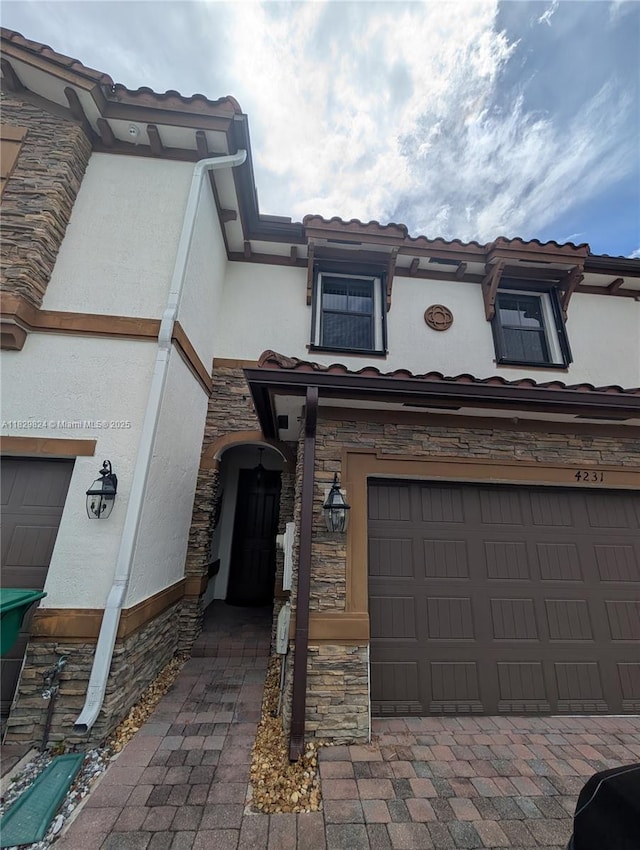 4231 SW 165th Ct, Miami, FL 33185 - view of front of home featuring stucco siding, stone siding, and an attached garage