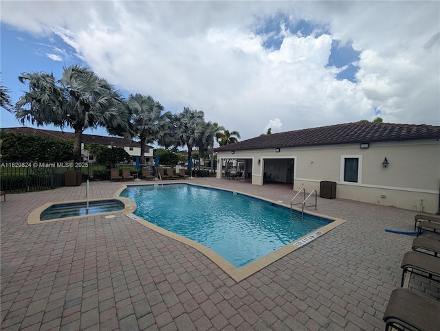 4231 SW 165th Ct, Miami, FL 33185 - view of swimming pool with a pool with connected hot tub and a patio