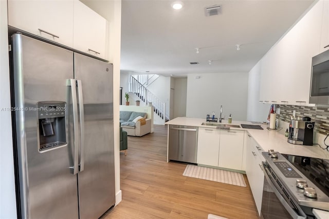 4269 NW 83rd Path, Doral, FL 33166 - kitchen with appliances with stainless steel finishes, white cabinetry, a peninsula, decorative backsplash, and recessed lighting
