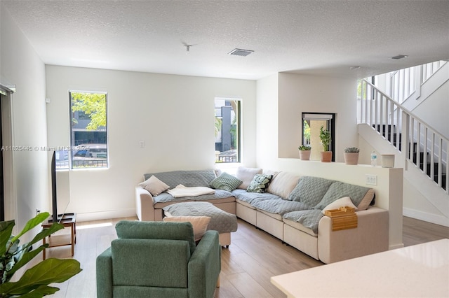 4269 NW 83rd Path, Doral, FL 33166 - living area featuring light wood-type flooring, a textured ceiling, and stairway