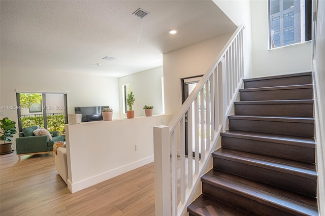 4269 NW 83rd Path, Doral, FL 33166 - stairway featuring healthy amount of natural light, wood finished floors, recessed lighting, and a textured ceiling