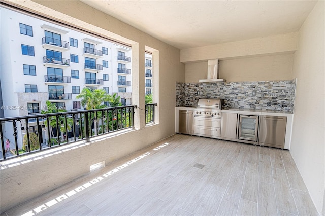 4269 NW 83rd Path, Doral, FL 33166 - bar area featuring wall chimney exhaust hood, beverage cooler, tasteful backsplash, wood finished floors, and a glass covered fireplace
