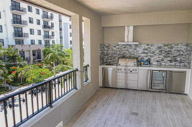 4269 NW 83rd Path, Doral, FL 33166 - kitchen with wall chimney exhaust hood, backsplash, light wood-type flooring, and beverage cooler