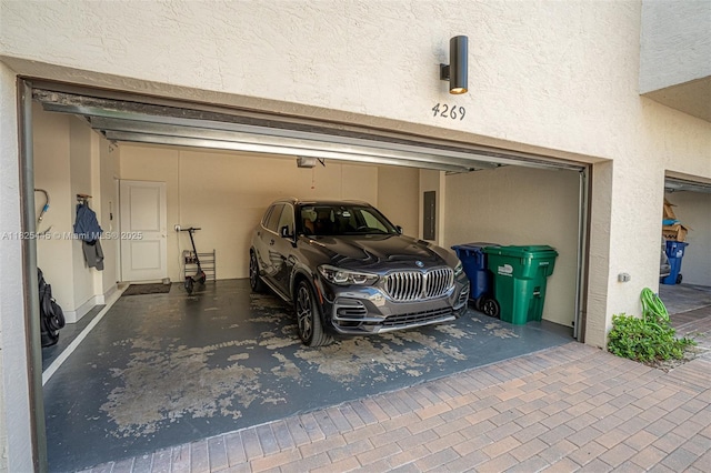 4269 NW 83rd Path, Doral, FL 33166 - garage featuring electric panel, a garage door opener, and driveway