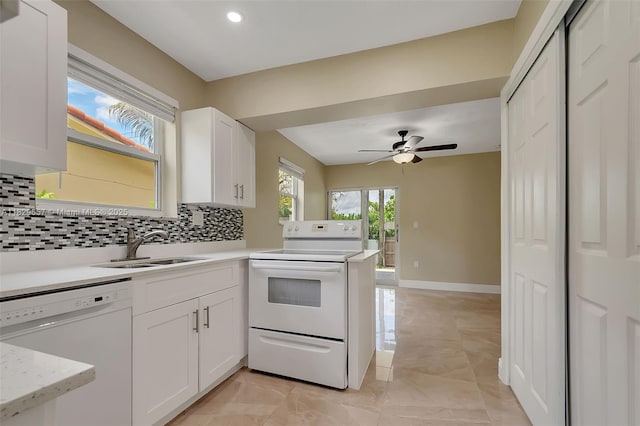 9241 SW 204th Ter, Cutler Bay, FL 33189 - kitchen with white appliances, decorative backsplash, a peninsula, a ceiling fan, and white cabinetry
