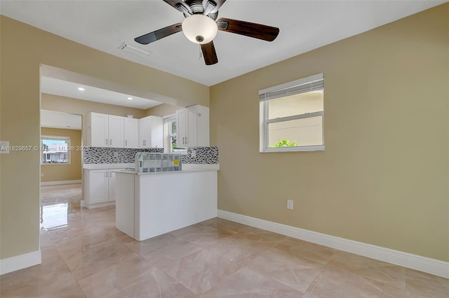 9241 SW 204th Ter, Cutler Bay, FL 33189 - kitchen featuring plenty of natural light, white cabinets, a ceiling fan, and a peninsula