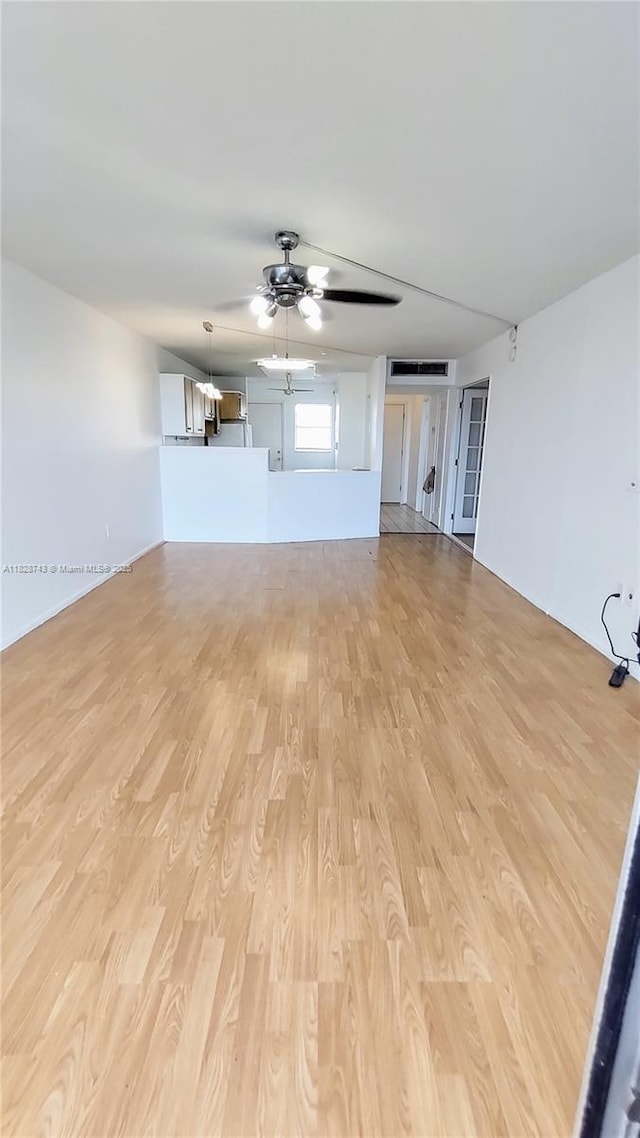 1780 NE 191st St Unit 704-2, Miami, FL 33179 - unfurnished living room featuring light wood-style flooring and ceiling fan