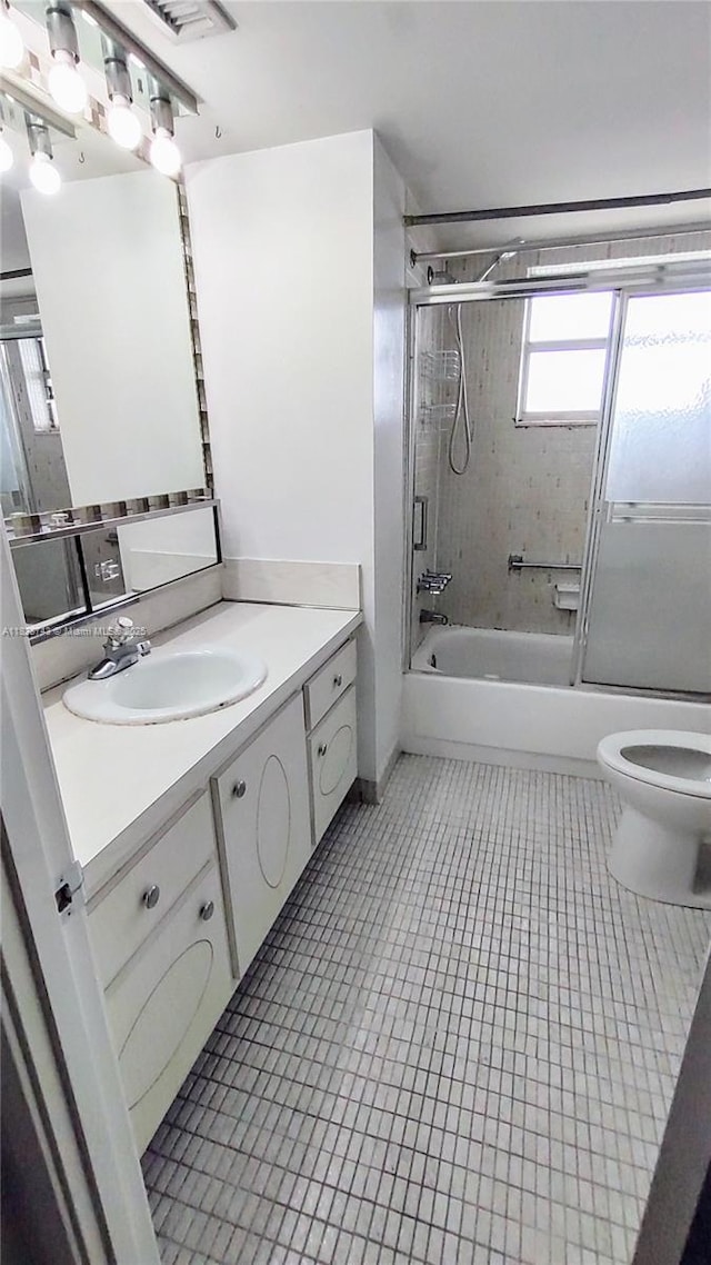 1780 NE 191st St Unit 704-2, Miami, FL 33179 - bathroom with vanity, bath / shower combo with glass door, and tile patterned floors