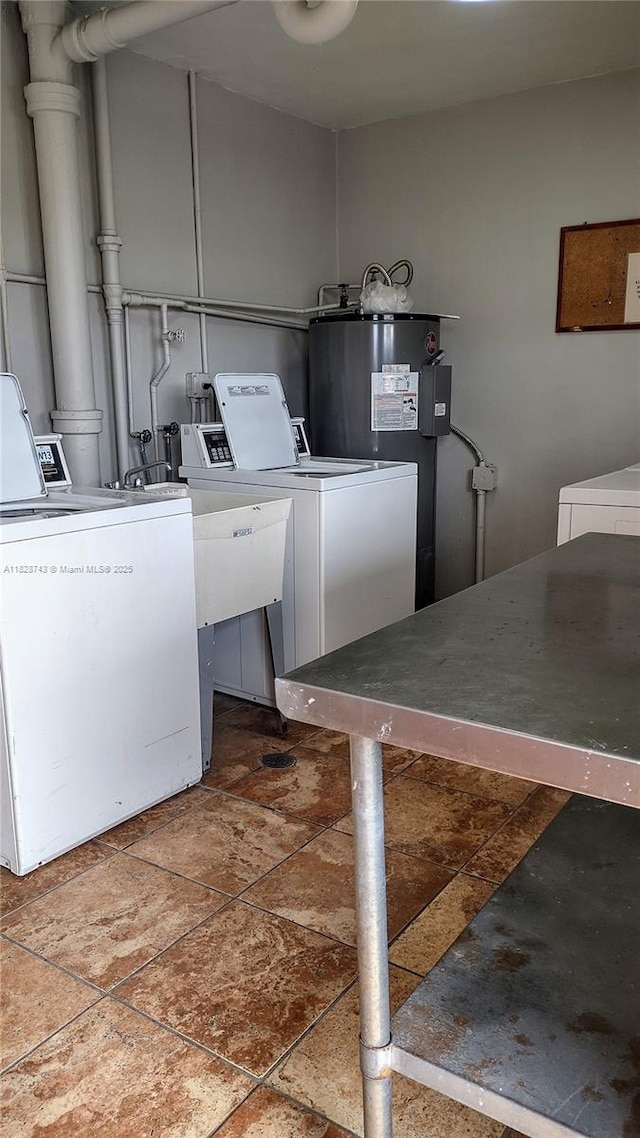 1780 NE 191st St Unit 704-2, Miami, FL 33179 - washroom with independent washer and dryer, stone tile flooring, and water heater