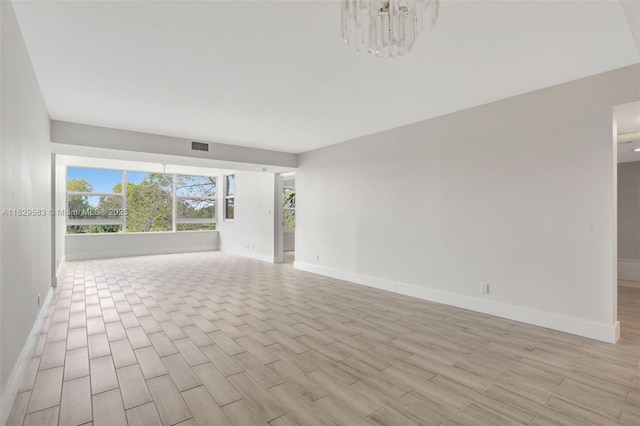 4091 Cypress Reach Ct Unit 301, Pompano Beach, FL 33069 - empty room featuring light wood-type flooring and a chandelier