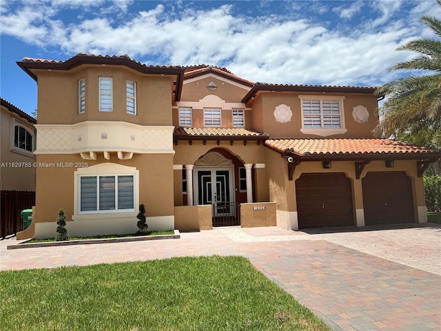 15445 SW 26th Ter, Miami, FL 33185 - mediterranean / spanish house with stucco siding, a garage, decorative driveway, a tile roof, and french doors