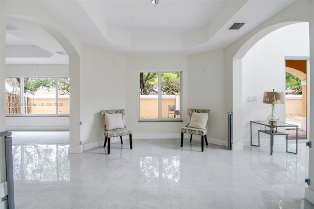 15445 SW 26th Ter, Miami, FL 33185 - living area featuring arched walkways, plenty of natural light, and a raised ceiling
