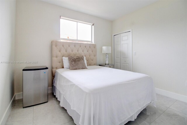 15445 SW 26th Ter, Miami, FL 33185 - bedroom featuring freestanding refrigerator, a closet, and light tile patterned floors