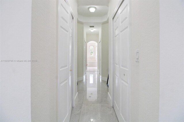 15445 SW 26th Ter, Miami, FL 33185 - hallway featuring a textured wall and arched walkways