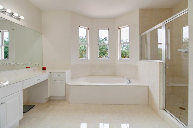 15445 SW 26th Ter, Miami, FL 33185 - full bathroom featuring vanity, a garden tub, a shower stall, and tile patterned flooring