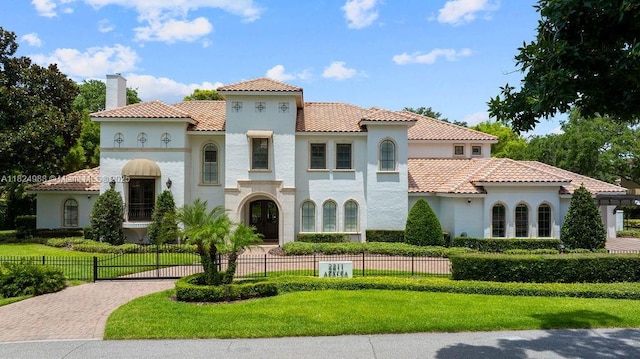 2211 Azalea Pl, Winter Park, FL 32789 - mediterranean / spanish-style house featuring stucco siding, a chimney, and decorative driveway