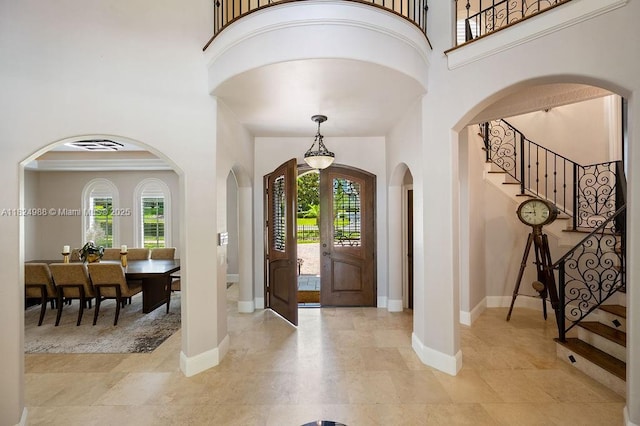2211 Azalea Pl, Winter Park, FL 32789 - entryway featuring stairway, a high ceiling, and arched walkways