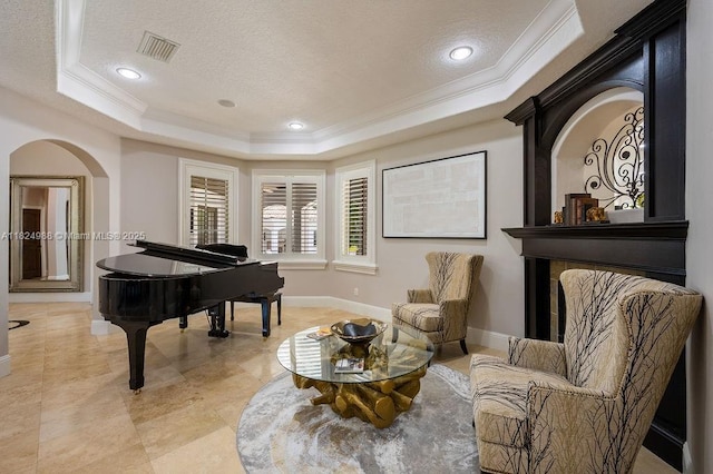 2211 Azalea Pl, Winter Park, FL 32789 - sitting room with a raised ceiling, ornamental molding, a textured ceiling, arched walkways, and recessed lighting