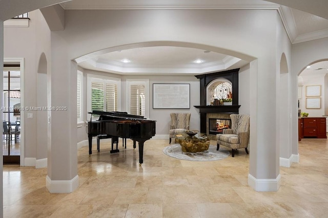 2211 Azalea Pl, Winter Park, FL 32789 - sitting room featuring arched walkways, crown molding, a multi sided fireplace, and a raised ceiling