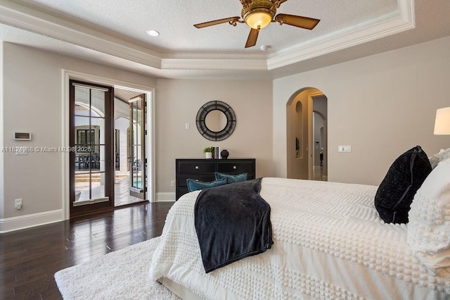 2211 Azalea Pl, Winter Park, FL 32789 - bedroom featuring a tray ceiling, arched walkways, access to exterior, multiple windows, and ornamental molding