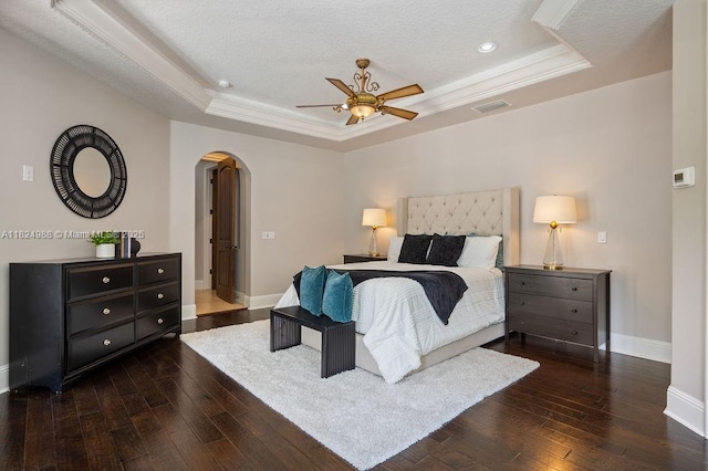 2211 Azalea Pl, Winter Park, FL 32789 - bedroom featuring a tray ceiling, arched walkways, hardwood / wood-style flooring, recessed lighting, and ornamental molding