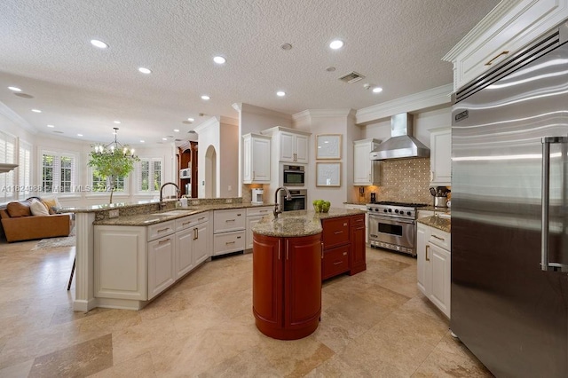 2211 Azalea Pl, Winter Park, FL 32789 - kitchen with high quality appliances, wall chimney exhaust hood, crown molding, tasteful backsplash, and open floor plan